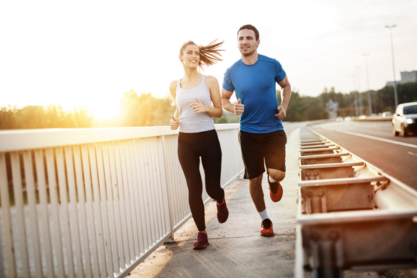 Active couple jogging outdoors during sunset - Reasons to Get Involved with an Aries Man
