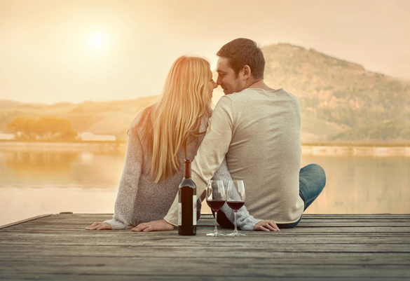 Romantic Couple sitting on the pier with red wine - How to get an Aries Man to Marry You